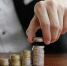 closeup-shot-of-a-businessman-s-hands-counting-stacks-of-coins-after-business-success - Новый Компаньон