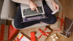 image-pleased-nice-woman-holding-credit-card-with-copy-space-using-laptop