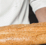close-up-male-baker-holding-fresh-bread - Новый Компаньон